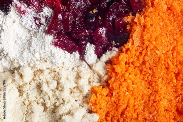 Fototapeta A close-up view of four distinct ingredients side by side: oat flour, ground almond, chopped plum, and grated carrot. The vivid colors and varied textures make this image visually appealing. Fodd.
