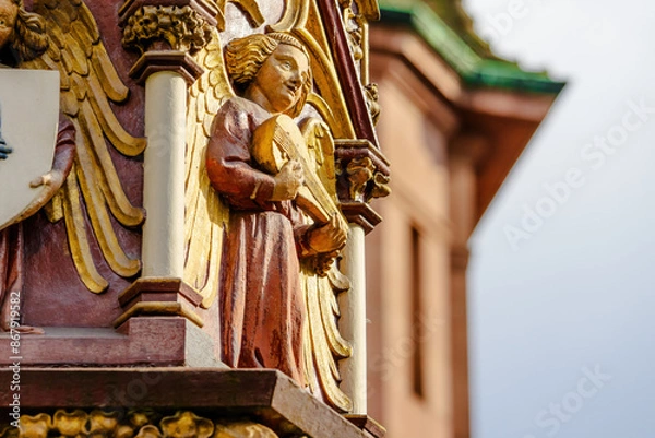 Fototapeta A large, ornate building with a gold and red color scheme