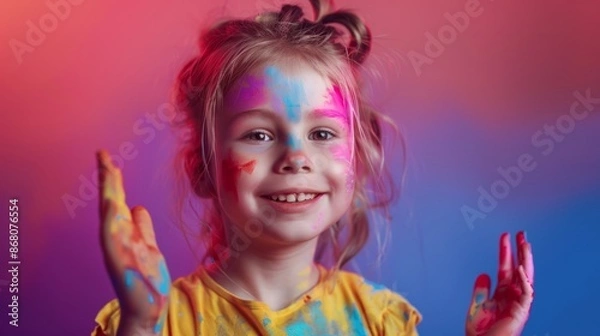 Obraz Portrait of a cute, smiling girl with paint painted on her face. Have fun playing shots.