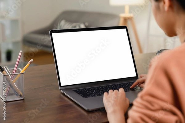 Fototapeta Woman hand using laptop and type on the keyboard, Mockup screen of advertisement.