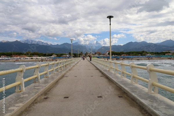 Obraz The famous pier in Forte dei Marmi, Italy which reaches out to the Ligurian sea. Located on the coast of the Tuscan region in Italy.  Few unrecognisable people in the far background.