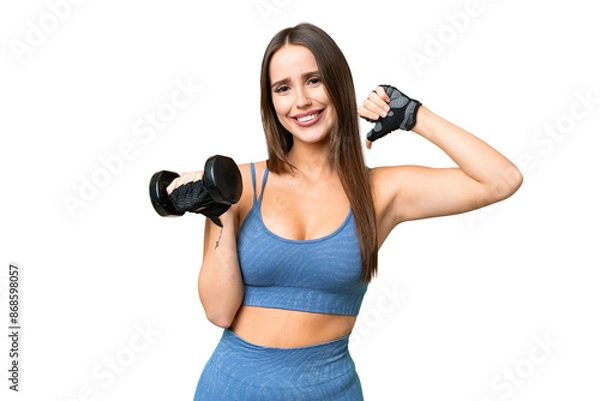 Obraz Young sport woman making weightlifting over isolated chroma key background proud and self-satisfied