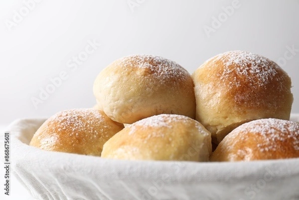 Fototapeta Delicious dough balls in basket on light background