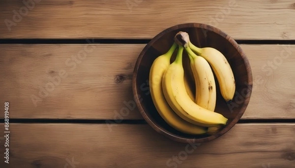 Obraz Top view of banana on a wooden bowl