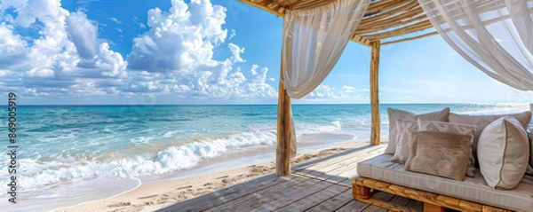 Fototapeta A cozy beachside cabana with comfortable seating, overlooking the ocean waves and inviting relaxation