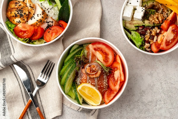 Fototapeta Beautiful composition with poke bowls on gray background with napkin