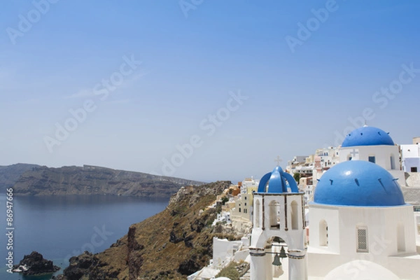 Fototapeta Santorini famous Orthodox church with blue domes in village Oia