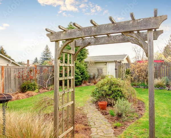 Fototapeta Authentic back yard with patio and greenery.