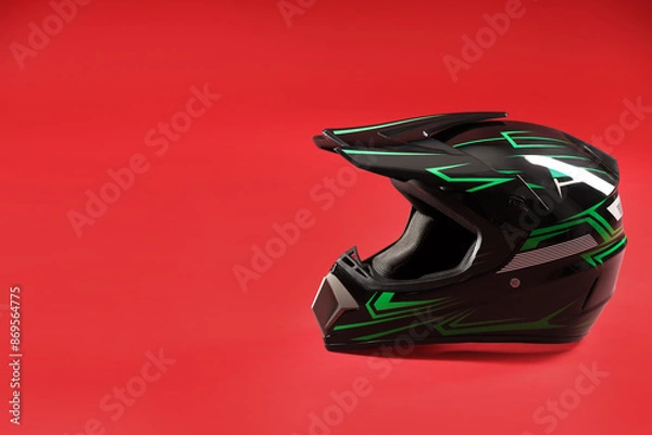Obraz Modern motorcycle helmet with visor on red background. Space for text