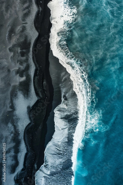 Fototapeta Aerial photo taken above from a drone, of black, rough, volcanic beach meeting the blue seas