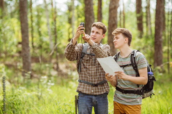 Fototapeta two tourist determine the route map and navigator