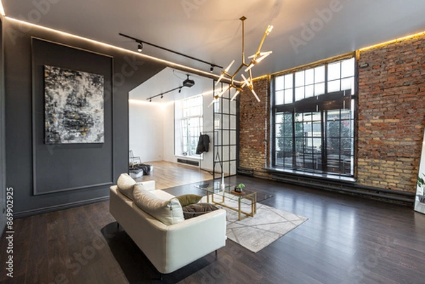 Obraz minimalistic stylish interior of luxury apartment with white stylish bedroom and dark living room. modern apartments with an open layout during the day without people and amazing sun rays