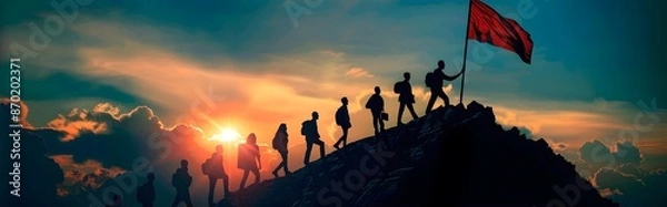 Fototapeta A group of people are on a mountain, with a red flag held by one of them