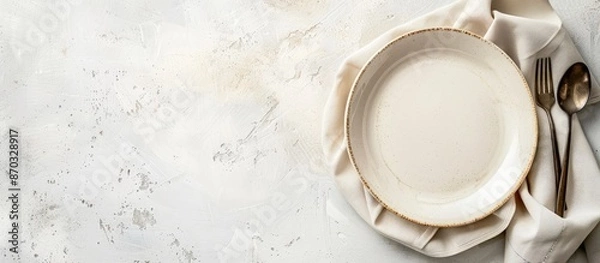 Obraz White table indoors with an empty plate, napkin, and copy space image available.