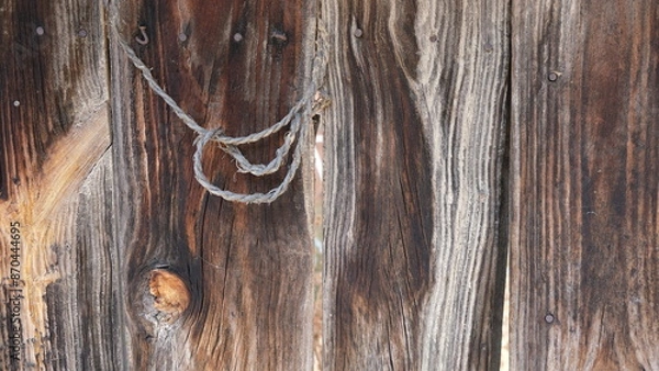 Fototapeta Visual composition for backgrounds. Combination of various textures. Wooden surface and a cordage on it. Image with deteriorated elements. Selection of old looking objects. Predominance of ocher tones
