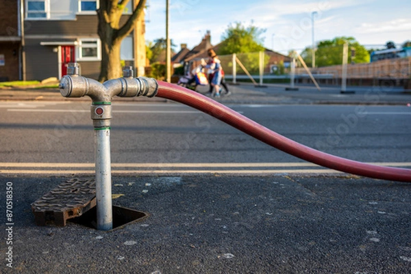 Obraz Fire hydrant connection point to supply water on road in england uk