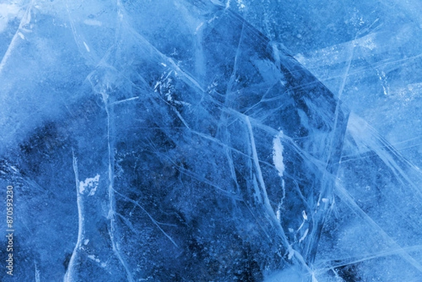 Fototapeta Beautiful crystalline ice texture. Cold background of blue ice with cracks and lines of icy surface of frozen Baikal Lake on winter. Unique ice pattern. Top view, flat lay, mockup, copy space