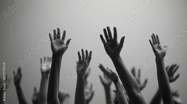 Fototapeta Many hands raised up high together, black and white banner