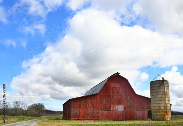 Fototapeta Red Wooden Barn With Silo and Dirt Lane