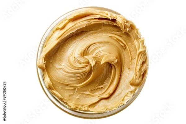 Fototapeta A small bowl filled with creamy peanut butter on a white surface, perfect for snacking or cooking