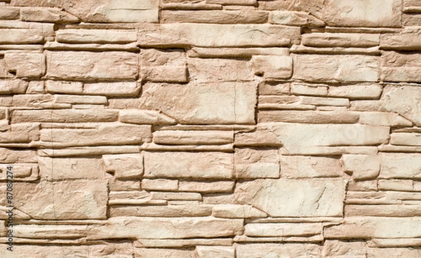 Fototapeta Decorative relief cladding slabs imitating stones on wall