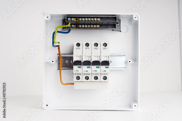 Fototapeta Electrical cabinet with four automatic fuses with wires. Ready for installing. Electricity distribution box. Fusebox. 
