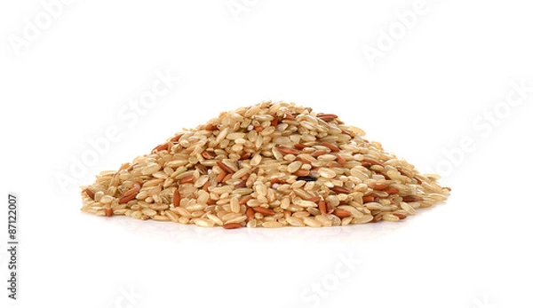 Obraz Pile of whole brown rice isolated on white background
