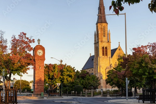 Fototapeta The iconic clock tower in the middle of roundabout at Mudgee with Church in background
