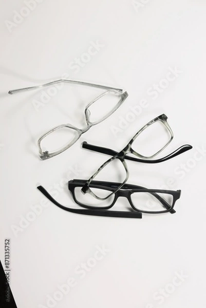 Fototapeta Three Pairs of Broken Eyeglasses on White Background