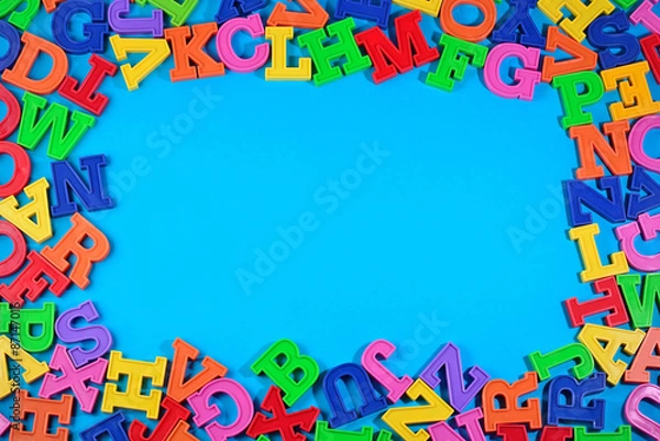 Obraz Frame of plastic colorful alphabet letters on a blue