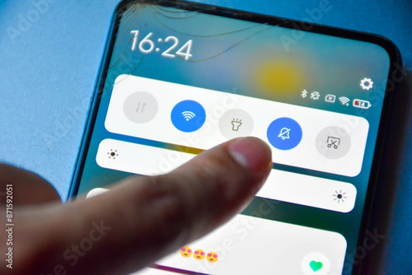Obraz Finger pressing to turn off notification mode on Android mobile phone display screen and notification of matches in dating applications, Finger presses off the interference button.
