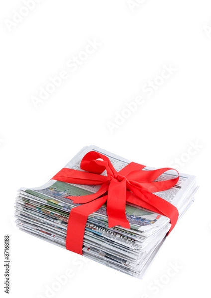 Fototapeta Newspaper stack with red bow