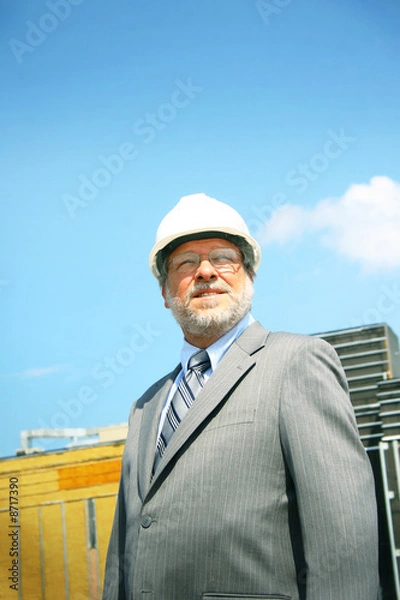 Fototapeta Business man with building in background