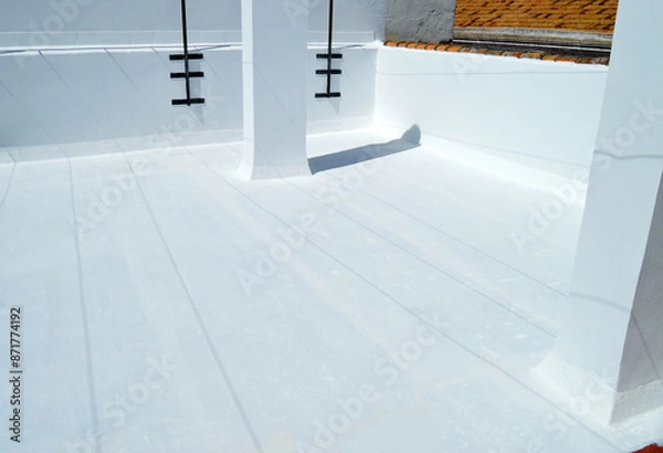 Fototapeta Terrace painted white to reduce the heat of summer sun. Waterproofing the house terrace with white rubber paint. Completely white building roof to combat high temperatures caused by climate change. 