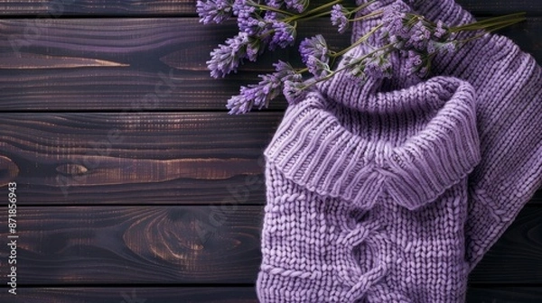Obraz Lilac gray knitted sweater neatly arranged on dark wooden background with space for text Flat lay