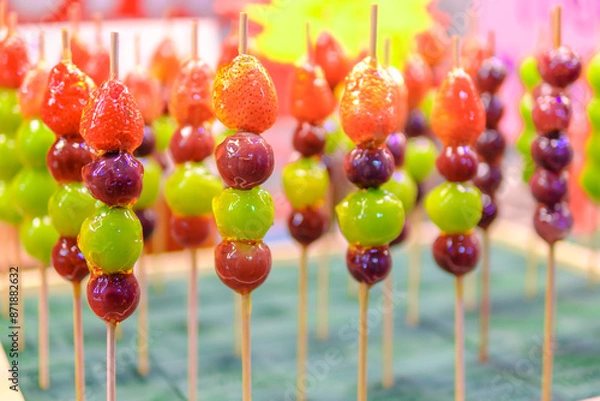 Fototapeta Beautifully arranged sugar-coated grape and strawberry. Tang Hu Lu