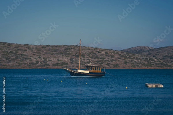 Obraz Charter wooden boat in the serene waters of Elounda Gulf, Crete, Greece