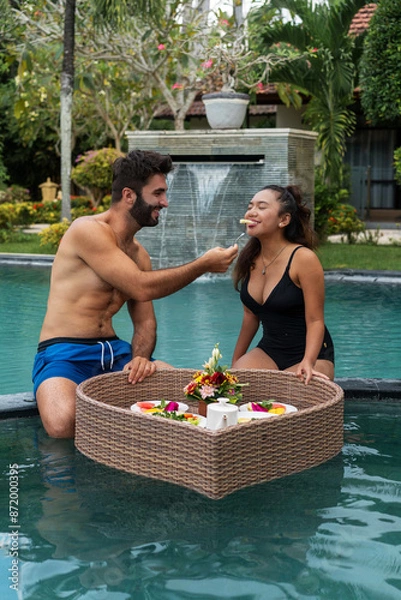 Obraz man and woman having breakfast in the pool