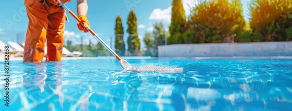 Fototapeta Close up shot of a swimming pool cleaner using a long pole with a net or brush to remove leaves and debris from a serene, cleaning service