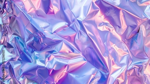 Fototapeta A mesmerizing shot of crumpled holographic foil reflecting pastel hues of pink, blue, and purple, creating a vibrant, dreamy, and futuristic abstract pattern.