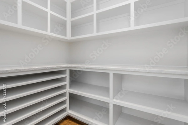 Fototapeta Empty Walk-In Pantry With White Shelving And Wooden Flooring, Well-Organized