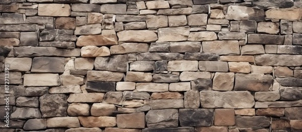 Fototapeta Retro stonewall background with old stone wall texture, rock blocks, ancient bricks fence, and a brickwork exterior mockup with copy space image.