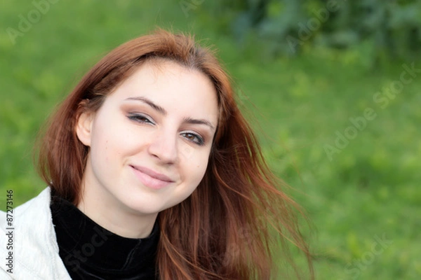 Obraz Portrait of red-haired girl in the park