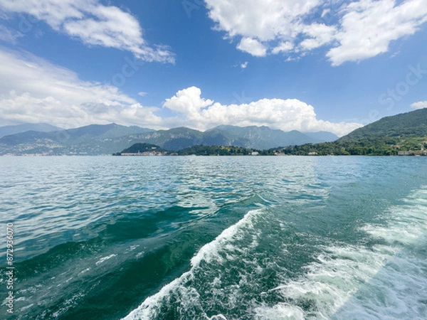 Fototapeta View at Lake Como and the Alps in Background and boats in foreground