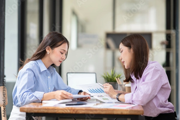 Fototapeta Business woman Discuss and plan work on graph documents at the office