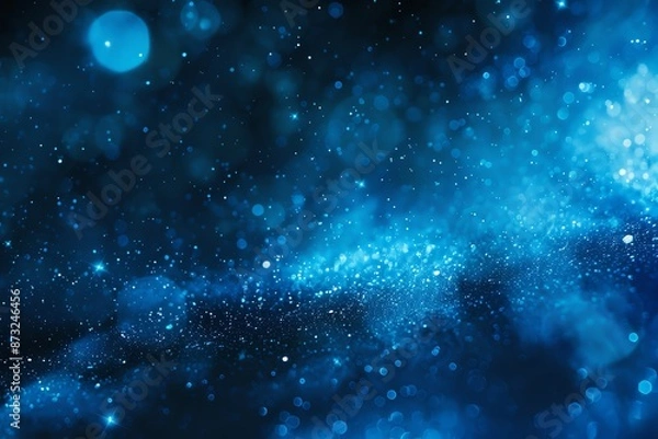 Fototapeta Abstract blue bokeh background with sparkling light effect, perfect for festive or cosmic themed designs.