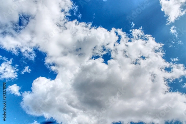 Obraz Clouds in a blue sky ,white fluffy clouds on a back ground of blue sky on a summers day Knottingley West Yorkshire In UK a HDR image
