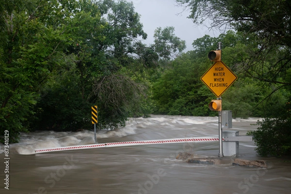 Obraz Flooded road with warning signs