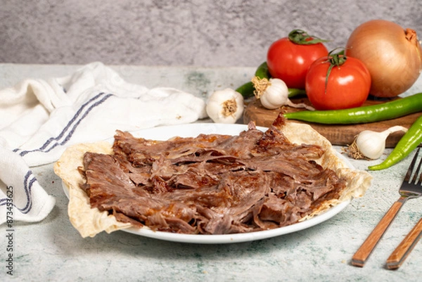 Fototapeta Meat Doner. Traditional Turkish cuisine taste. Cooked meat doner kebab on gray background. local name et doner. Close up