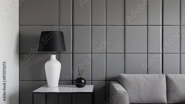 Fototapeta Grey wall panels and a black side table in minimalistic interior design composition.
